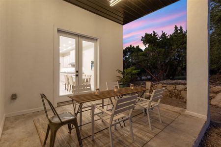 Covered back patio with metal roof & contemporary custom lighting.