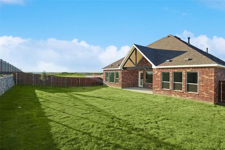 Rear view of house with a yard and a patio area