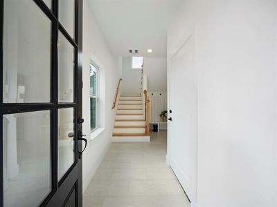 The stunning entryway features a charming mud section and leads to the first bedroom on the first floor.