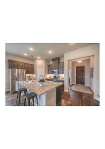 Kitchen featuring dark brown cabinetry, light stone countertops, a center island with sink, a breakfast bar, and appliances with stainless steel finishes