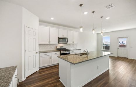 Airy kitchen with ample cabinet space*real home pictured