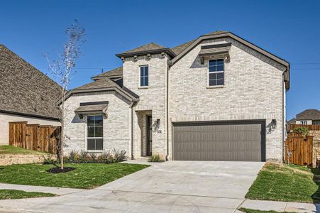 View of front of house featuring a front lawn and a garage