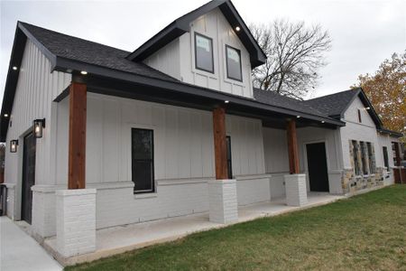 View of side of home featuring a lawn