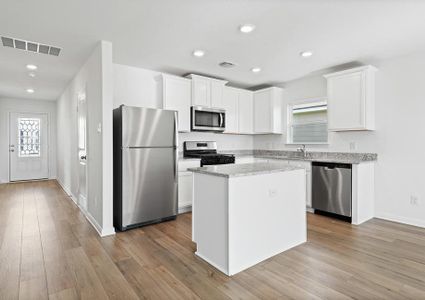 The kitchen comes with white cabinets and granite countertops.