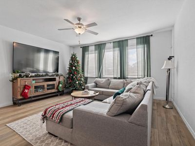 Living room featuring ceiling fan and hardwood / wood-style floors