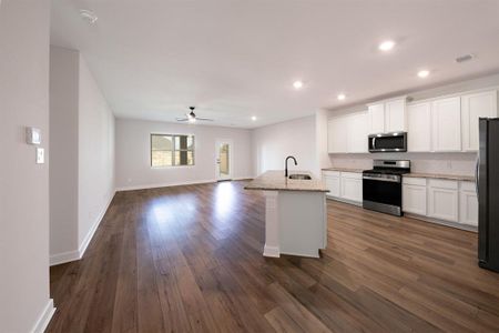 With an open layout, the kitchen island becomes the focal point, offering a spacious and inviting atmosphere that encourages family members to gather, chat, and enjoy each other's company while meals are prepared.