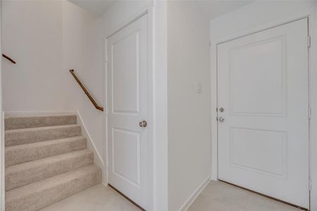 Stairway featuring light tile patterned floors