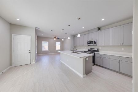 The dining area boasts ample space, creating a perfect setting for family gatherings and entertaining guests. With room for a large dining table, it offers flexibility for various occasions. Large windows allow natural light to fill the space, enhancing its inviting atmosphere and making mealtime a delightful experience.