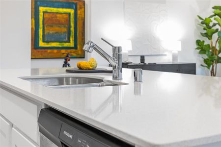 Details with dishwasher, light countertops, and a sink