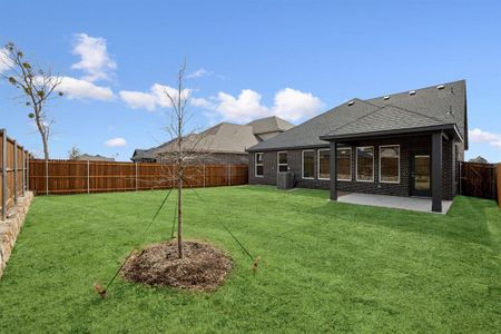 Back of house with a fenced backyard and a covered patio area