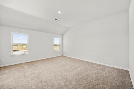 Large, primary bedroom with beautiful windows.