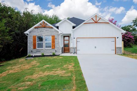 View of front of home with a garage and a front yard