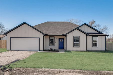 View of front of home with a front yard and a garage