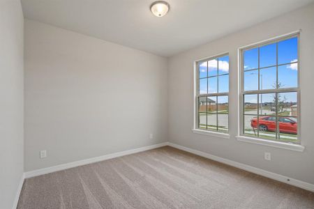 Your secondary bedroom features plush carpet, fresh paint, closet, and a large window that lets in plenty of natural lighting.