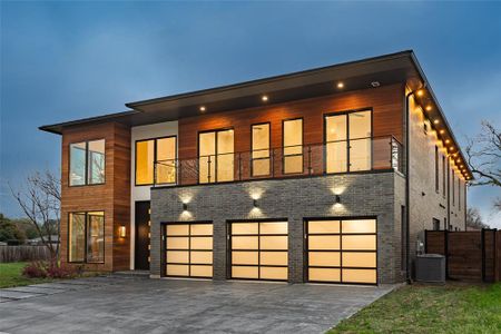 Contemporary home featuring a balcony, a garage, and central AC