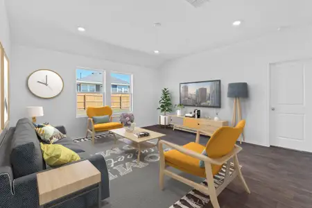 Living area with recessed lighting, vaulted ceiling, baseboards, and wood finished floors