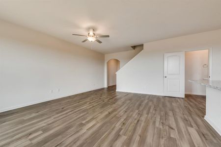 Unfurnished living room with light hardwood / wood-style flooring and ceiling fan