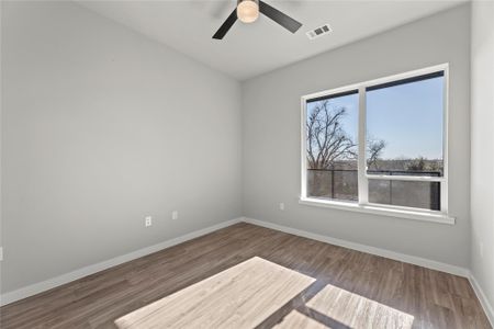 Empty room with hardwood / wood-style flooring and ceiling fan