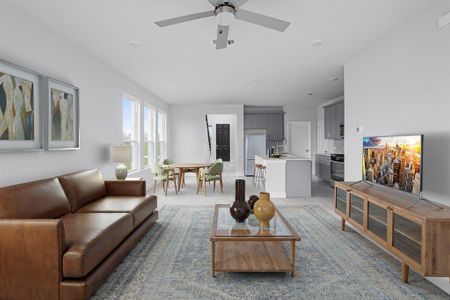 Living area with ceiling fan and light colored carpet