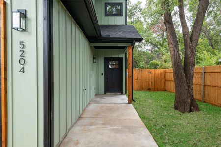 Entrance to property with a lawn