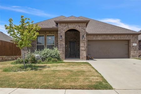 View of front of house with a garage and a front lawn