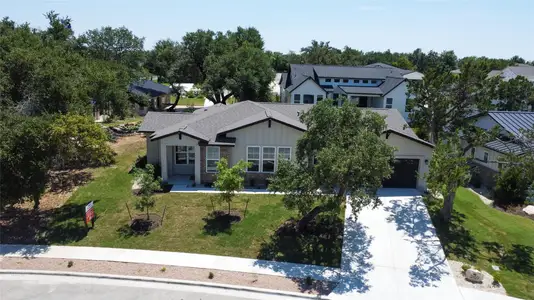 View of front of house with a garage and a front lawn