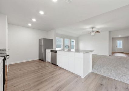 The family room of the Reed  sits adjacent to the kitchen.