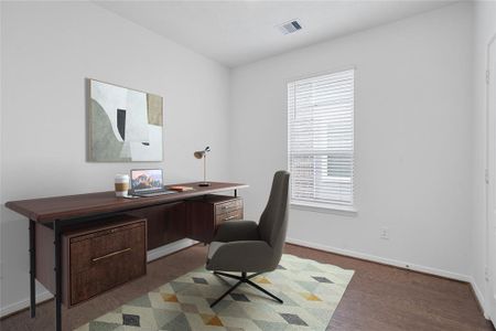 Quietly nestled in front of the home is the handsome home office or formal dining room. Featuring gorgeous engineered wood flooring, custom paint and a large window with privacy blinds.