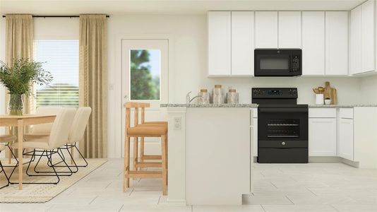 Kitchen with light stone countertops, white cabinets, and black appliances