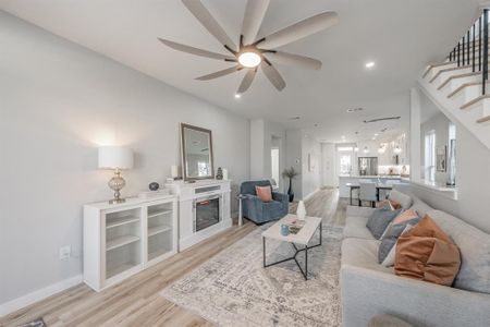 Living room featuring light hardwood / wood-style floors and ceiling fan