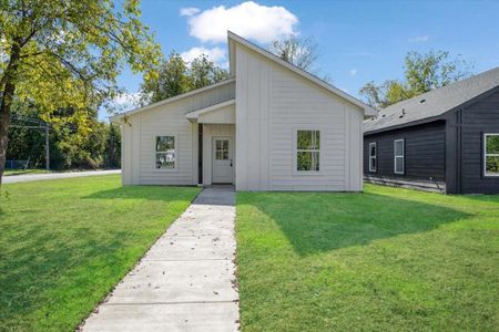 Back of house with a yard