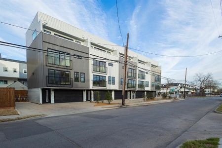 View of building exterior featuring driveway and an attached garage