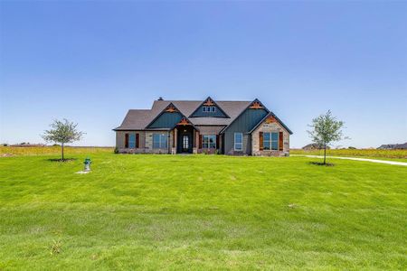 Craftsman inspired home with a front yard