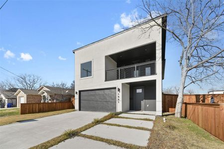 Contemporary home featuring a garage and a balcony