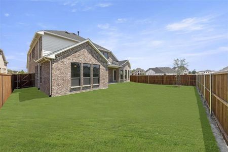 Rear view of house featuring a lawn