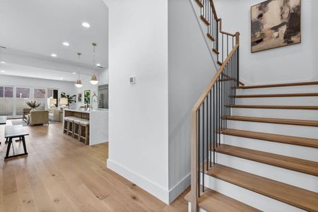 Stairs with hardwood / wood-style floors and sink