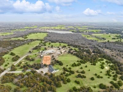 Birds eye view of property with a water view and a rural view