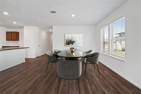 Start your day off right with a cup of coffee sitting with your family in the lovely breakfast/dining area! Featuring large windows with blinds, custom neutral paint, tile flooring, recessed lighting and high ceilings!