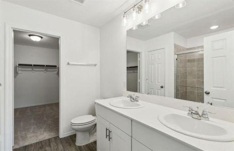 Elegant owner's bathroom with dual vanity *real home pictured