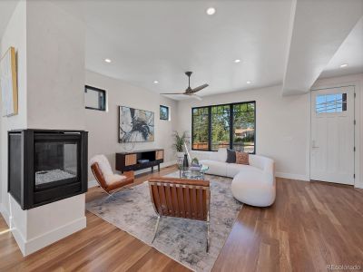 Living room with west facing window, 3 side fireplace