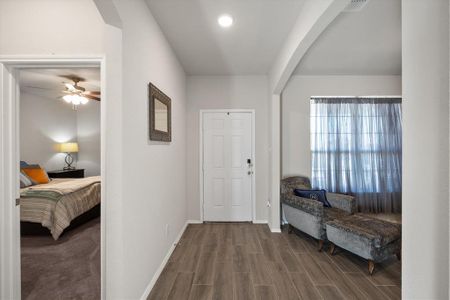 Entrance foyer with hardwood / wood-style floors and ceiling fan