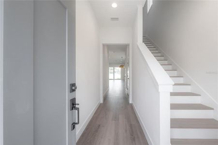 Solid wood stair treads. Specific finish colors may be differ. Photo is from another completed unit.