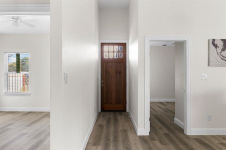 Entryway with ceiling fan and hardwood / wood-style flooring