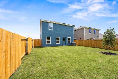 Back of property featuring central AC unit and a lawn