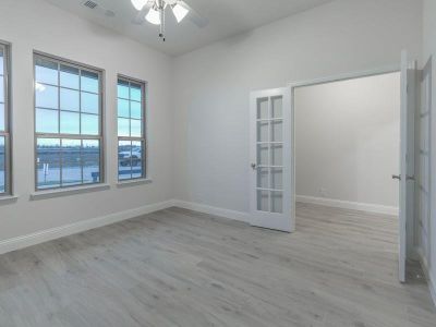 Unfurnished room featuring ceiling fan and light hardwood / wood-style floors