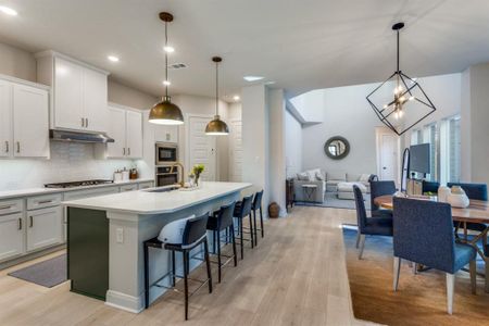 Kitchen with visible vents, appliances with stainless steel finishes, a sink, under cabinet range hood, and backsplash