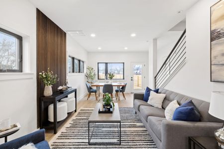 Living room with light wood finished floors, recessed lighting, stairs, and baseboards