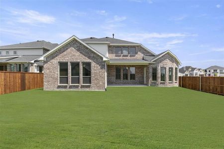 Rear view of property featuring a lawn