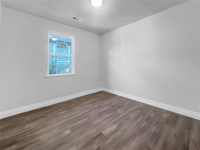 Unfurnished room with dark hardwood / wood-style flooring