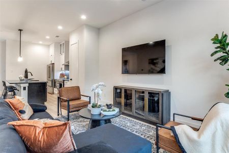 Living room featuring light hardwood / wood-style flooring and sink